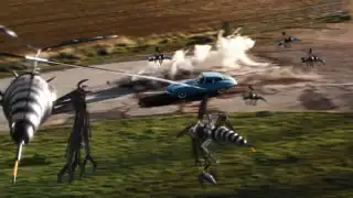 A swarm of robotic drone wasps attack Mrs. Peel’s blue E-type Jaguar