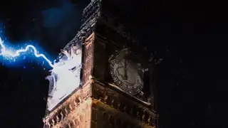 A lighning bolt strikes one of the faces of the clock tower of the Houses of Parliament, causing glass to shatter from all sides