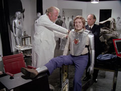 Mason and Malov strap Kane into his cybernautic suit