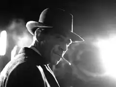 Publicity still: Frank Preston dramatically lit by a streetlight, looking like Bogart