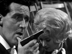Steed, holding Stepan’s pistol, lies to Venus about never getting her in danger again