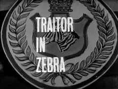 title card: white all caps text reading ‘TRAITOR IN ZEBRA’ superimposed on the coat of arms of the base - a zebra in a shield surmounted by a crown, surrounded by laurel leaves