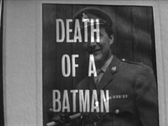 title card: white all caps text reading ‘DEATH OF A BATMAN’ superimposed on photograph of Steed in Army uniform