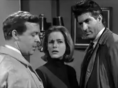 Cathy stands between Manley, on the right, and Westwood, confused that they have just arrested her for the murder of Spagge