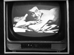 The monitor shows the content of the microfilm - a holiday snap of Steed at the beach