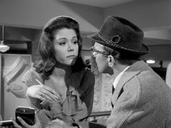 Mrs. Peel ponders the wisdom of giving her phone number to the house dick