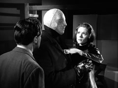 Mrs. Peel tips the fused cybernaut backwards with her index finger