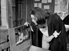 Mrs. Peel smirks when she finds a lingerie photo pasted to the inside of one of the student’s desks
