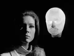 A plastic mould of Professor Keller’s head glows in the blackness behind Emma