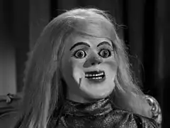 Close-up of the creepy ventriloquist’s dummy which gives the women their orders