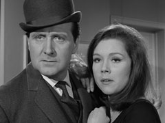 Steed and Emma hold each other close as they are surrounded by the women and face Henrietta
