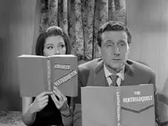 Steed and Emma read books on ventriloquism ( ‘ADVANCED VENTRILOQUISM’ and ‘THE VENTRILOQUISTS’) inside a moving caravan