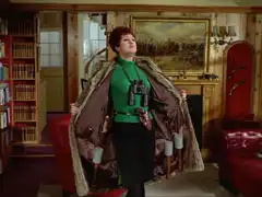 Olga throws open her fur coat to reveals grenades, pistols, knives and a pair of binoculars. She stands in the middle of Steed’s pine-lined flat, a print of ‘Charge of the Light Brigade’ by Robert Hillingford (1899) over the fireplace