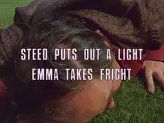 subtitle card: white all caps text with black dropshadow to the left reading ‘STEED PUTS OUT A LIGHT
			EMMA TAKES FRIGHT’ superimposed on a close-up of Meadows lying face-down on the turf in fear