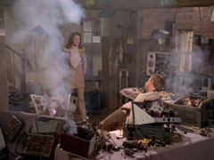 Mrs. Peel re-enters Aerial Cottage to find all the radios smashed and George Eccles dead.