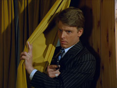 Teddy appears from behind Steed’s curtains wielding a service revolver