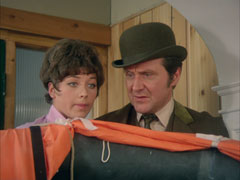 Tara and Steed are trapped in a corner of his flat after he accidentally makes the liferaft inflate itself