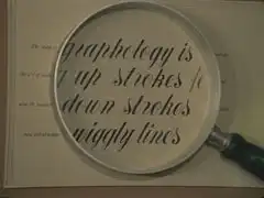 sign at the graphologists - a false magnification of some text: ‘The study of graphology is [..ent one] The art of reading up strokes together also the reading [of] down strokes [in combin]ation and interpreting wiggly lines’