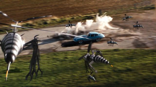 A swarm of robotic drone wasps attack Mrs Peel’s blue E-type Jaguar