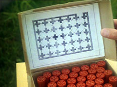 Close-up of the inside of yyy’s box of shotgun shells, showing the black and white maze map which has been glued there