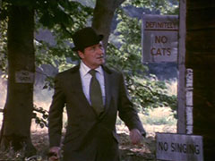 Steed arrives at Bridlington’s hut which is dotted with signs forbidding cats and singing