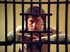 Gambit peers angrily through the bars of his prison cell