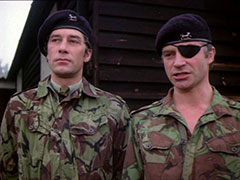 Gambit, in the uniform of a Scottish regiment, stands at attention beside his new CO, Col Mad Jack Miller, who is similarly attired in camouflage fatigues and wears a black eyepatch on his left eye