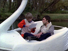 Puredey and Gambit sit in one of the swan boats on Lake Ontario as they examine some documents
