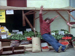 George Cuvalo is sent flying into the vegetable stand outside the grocery store