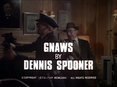 title card: white all caps text reading ‘GNAWS BY DENNIS SPOONER’ superimposed on Carter knocking out the guard at the Ministry