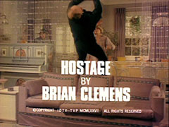 title card: white all caps text reading ‘HOSTAGE BY BRIAN CLEMENS’ superimposed on Purdey kicking her assailant backwards over her sofa