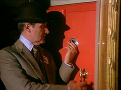 Steed cracking the lock of a large red safe