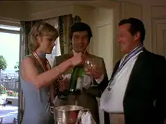 Decorated with Soviet medals, the Avengers toast each other with champagne, Gambit and Steed struggle due to their injuries