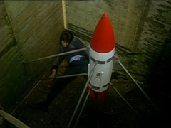 Wolach’s dead body lies dumped in the corner of the makeshift missile silo