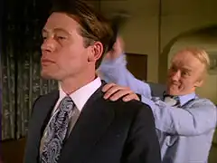 Wallace stands still, nearest us, and waits as Richards to hits him over the head, one hand on his shoulder so Wallace doesn’t move