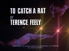 title card: white all caps text reading ‘TO CATCH A RAT BY TERENCE FEELY’ superimposed on two acrobats on a dark background with two spotlights behind them. The acrobat at top right has retracted his hands and the other is now falling, arms outstretched, to his doom