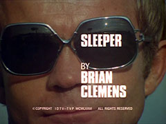 title card: white all caps text reading ‘SLEEPER BY BRIAN CLEMENS’ superimposed on an extreme close-up of Brady wearing sunglasses