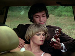 Purdey rests against Gambit, who holds up the brown glass bottle of the antidote