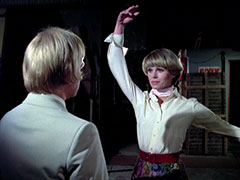 Purdey stops Ranson on the stage of the theatre and strikes a balletic pose before they fight