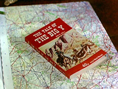 The paperback book from Braqndon’s package, ‘The Tale of the Big Y’ sits on top of a map of the area. The book’s cover is red with white text and has a sepia drawing of three cowboys before some mountains, rounding up a cow which is branded with a Y on the rump
