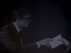 A blurry black and white photo, but it shows Harmer handing over documents to the enemy clearly enough for his to be guilty