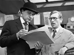 publicity still: Steed visits Sampson, posing as a union delegate investigating misappropriation of funds