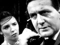 Steed takes a call while Carol looks worried