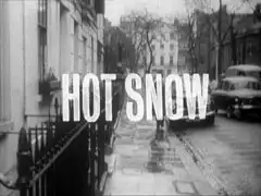 title card : HOT SNOW superimposed on a view up a quiet, rain-swept street in Chelsea