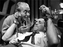 publicity still: Dr Keuzer threatens a restrained Dr Keel with the hypodermic needle that will send him to sleep
