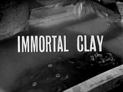 title card: white all caps text reading 'IMMORTAL CLAY' superimposed on the water tank containing the 'corpse'