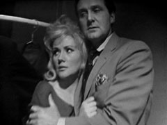 Steed and Mara cling to eachother as they hide in the wardrobe