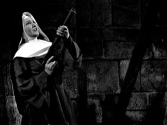 The Mother Superior fires a hail of bullets from her submachinegun up the ladder