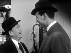 Steed  greets Gregory jovially and they discuss their tailor