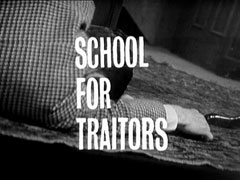 title card: white all caps text reading ‘SCHOOL FOR TRAITORS’ superimposed on Davis slumped on the floor in a tweed jacket